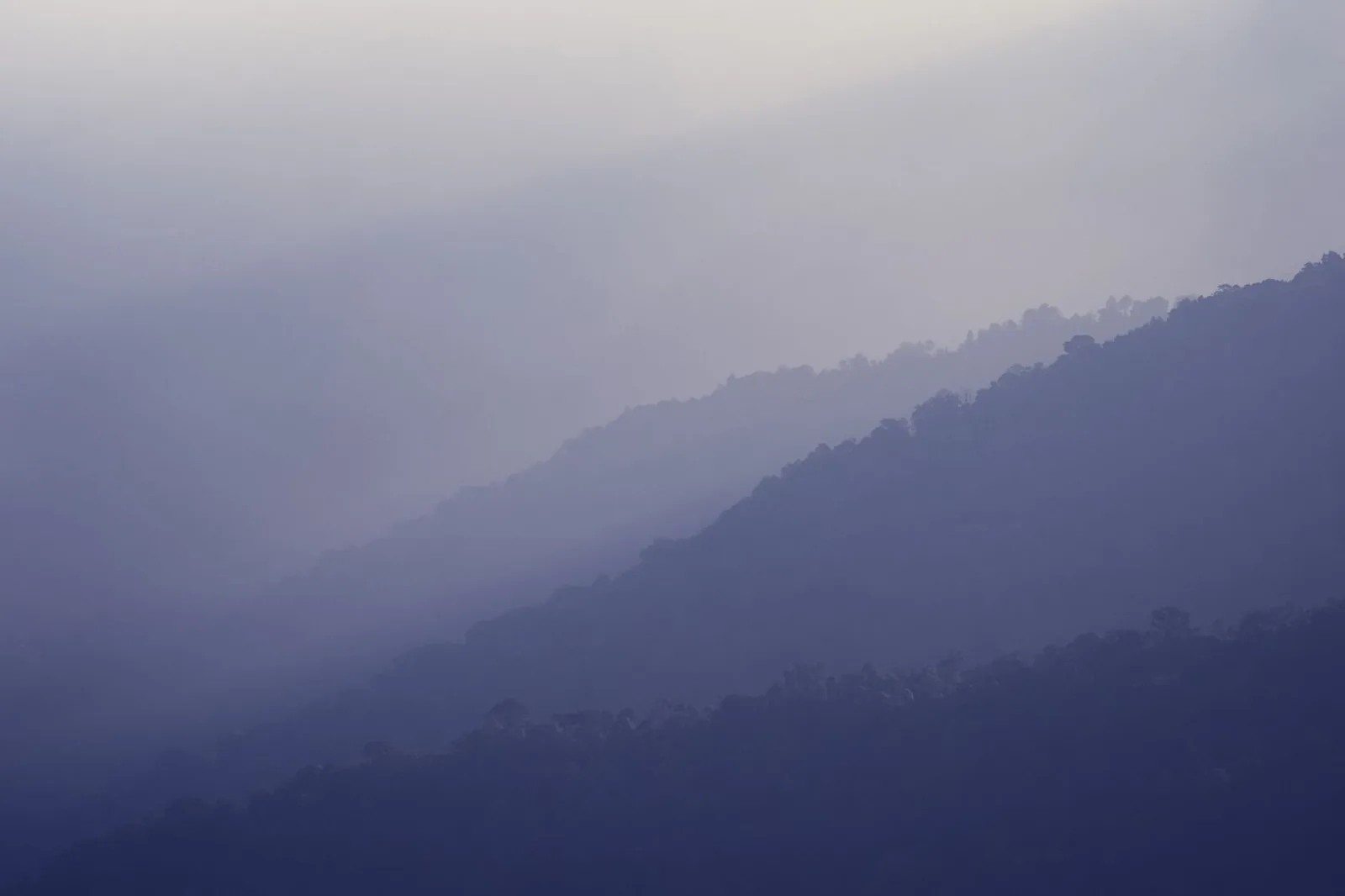Layers of misty blue mountains fading into the distance